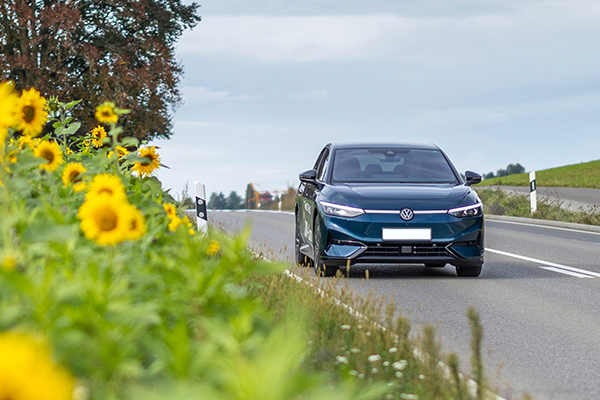 Electric Car on Country Road with Sunflowers
