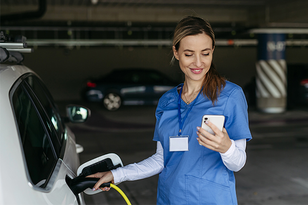 nurse charging an electric car